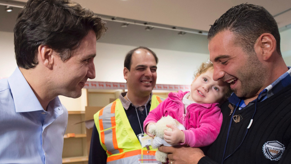 PM Justin Trudeau greets Syrian refugees arriving at Pearson Airport, Toronto, Dec. 11, 2015